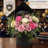 Flower arrangement in a graduation hat box for woman