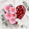 Heart with pink gerberas and chocolates