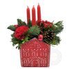 Christmas arrangement with candles in a ceramic house