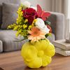Yellow ceramic flower with flower arrangement