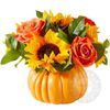 Sunflowers and orange roses in a pumpkin