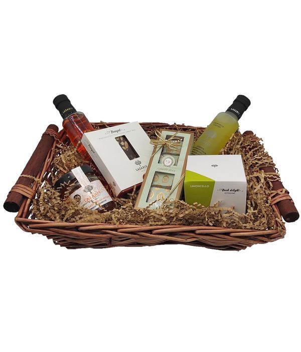 Basket with liqueur and sweet delicacies
