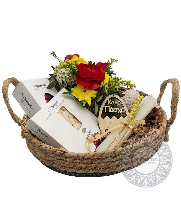 Flower arrangement in a wicker basket and sweet treats