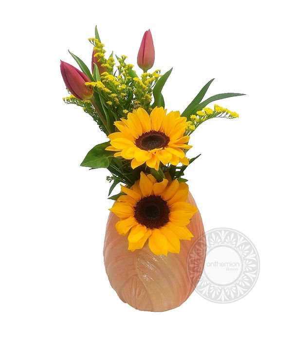 Sunflowers and tulips in a special vase