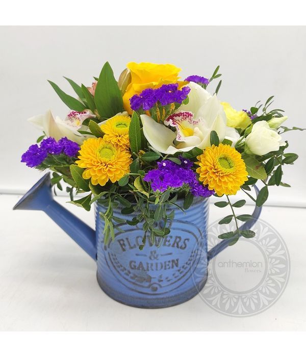 Watering can with flowers in blue-yellow