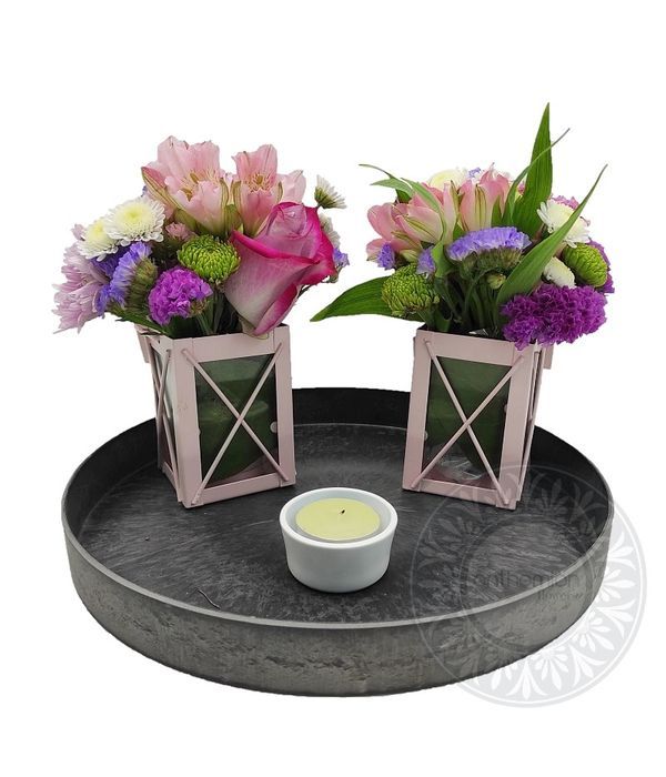 Small lanterns with flowers on a tray