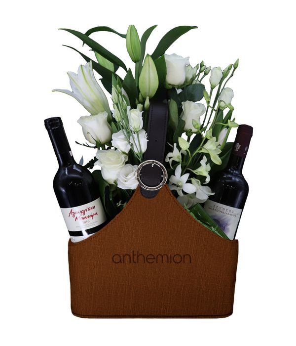 Brown leather newspaper case with two wines, white flowers