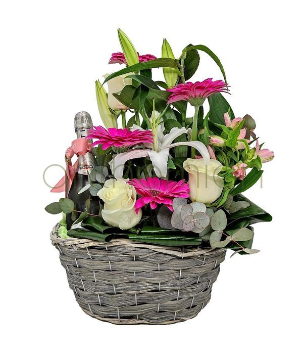 Basket with sparkling wine and flowers