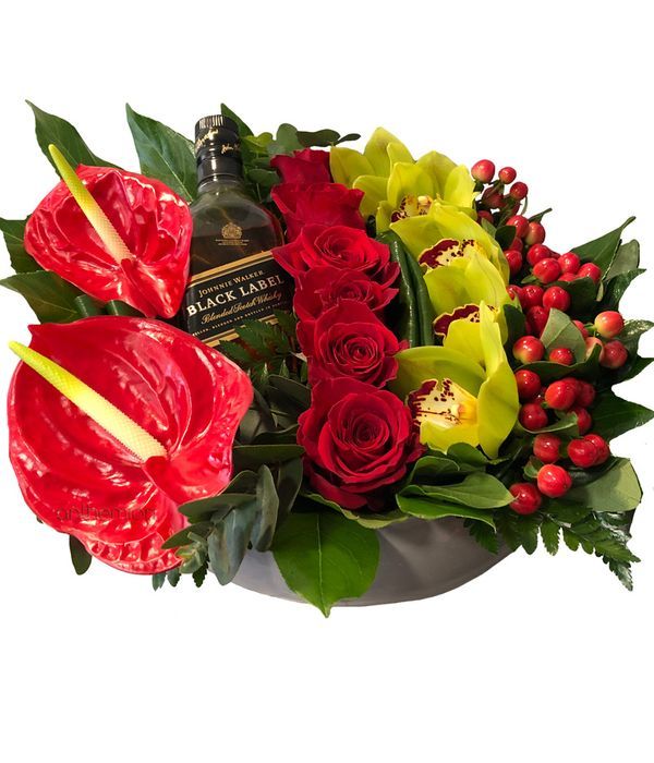 Floral arrangement with a bottle of whiskey