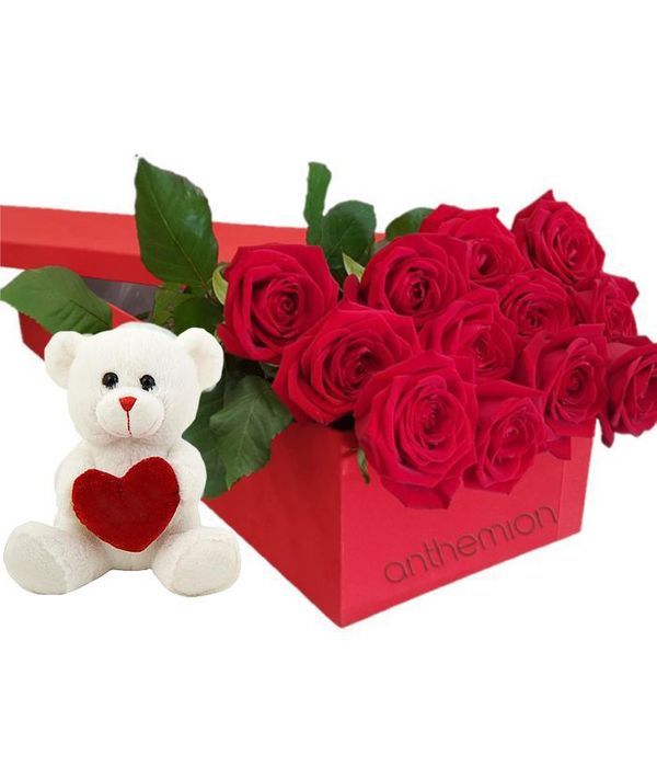 Roses and teddy bear in gift box