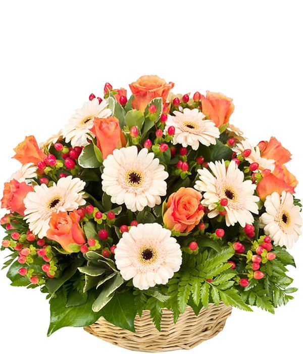 Basket arrangement with orange and cream flowers