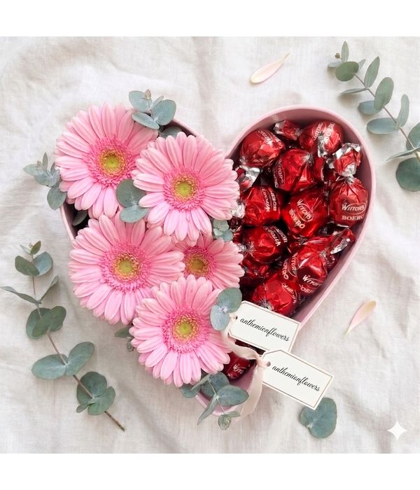 Heart with pink gerberas and chocolates