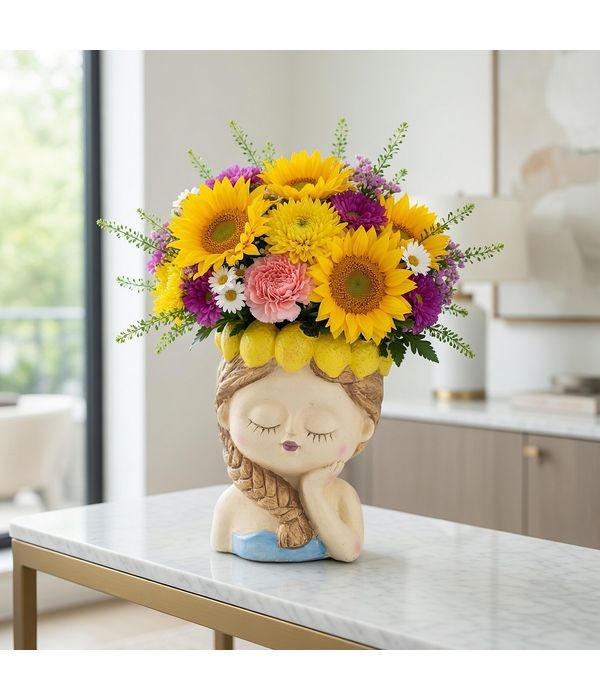 Ceramic head with lemons and flower arrangement