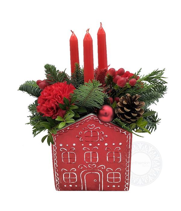 Christmas arrangement with candles in a ceramic house