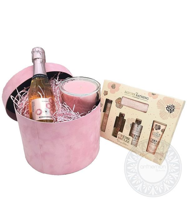 Pink box with small prosecco bottle, candle and care set
