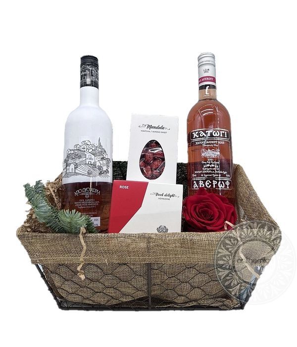 Basket with rosé wines and sweet treats