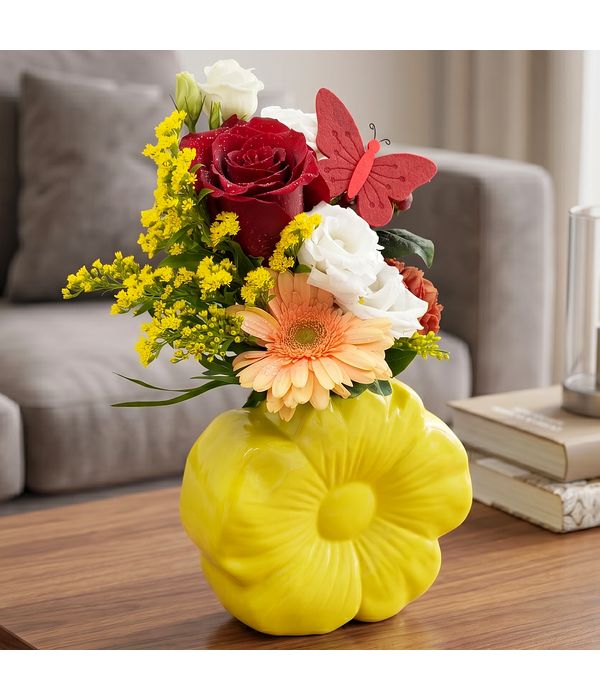 Yellow ceramic flower with flower arrangement