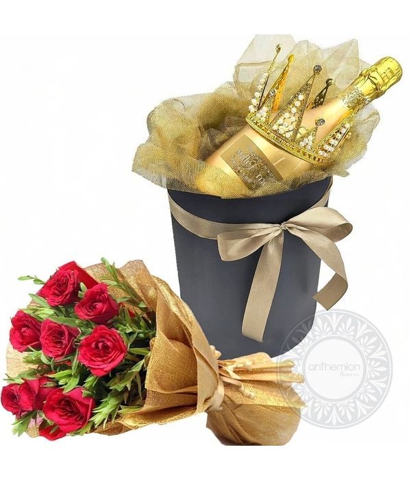 Golden gift with prosecco and red roses