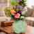 Green ceramic flower with flower arrangement